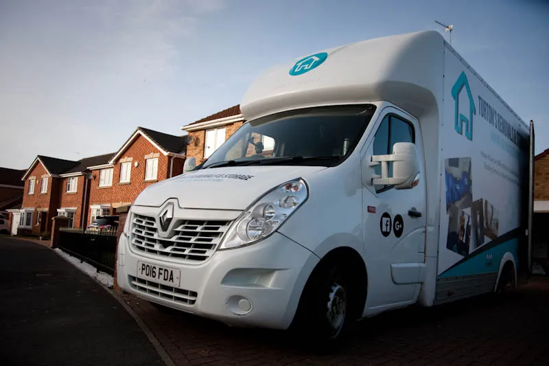 Turton's Removals & Storage van and uniformed crew preparing a European removal
